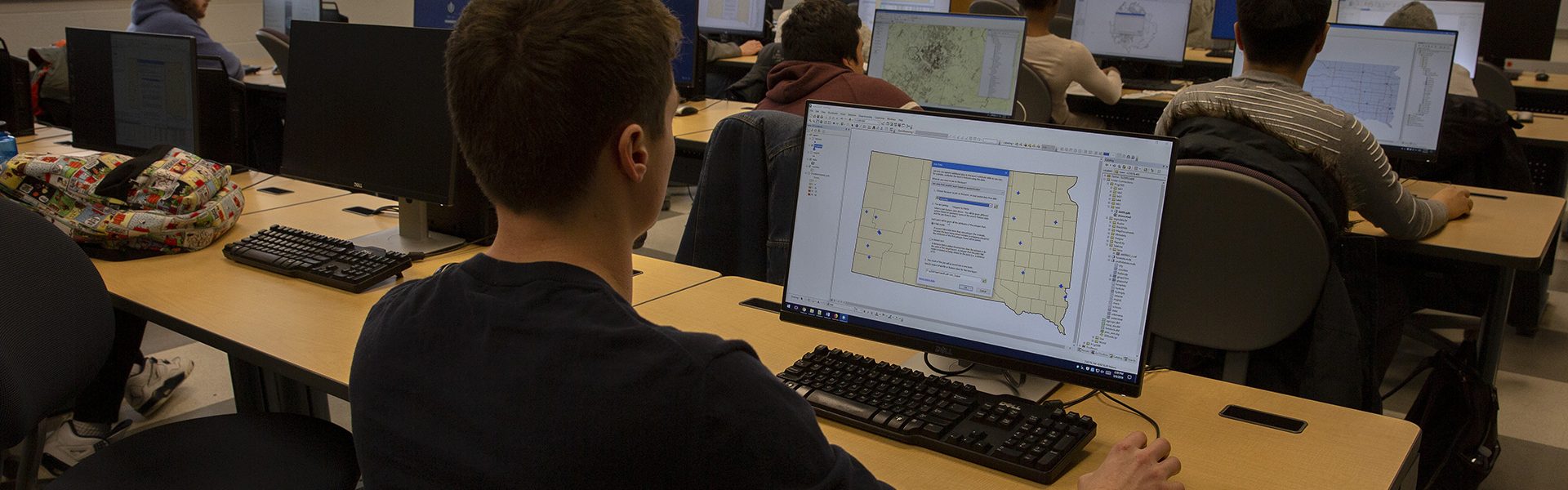 gis-class-computer A student looks at a map on a computer.