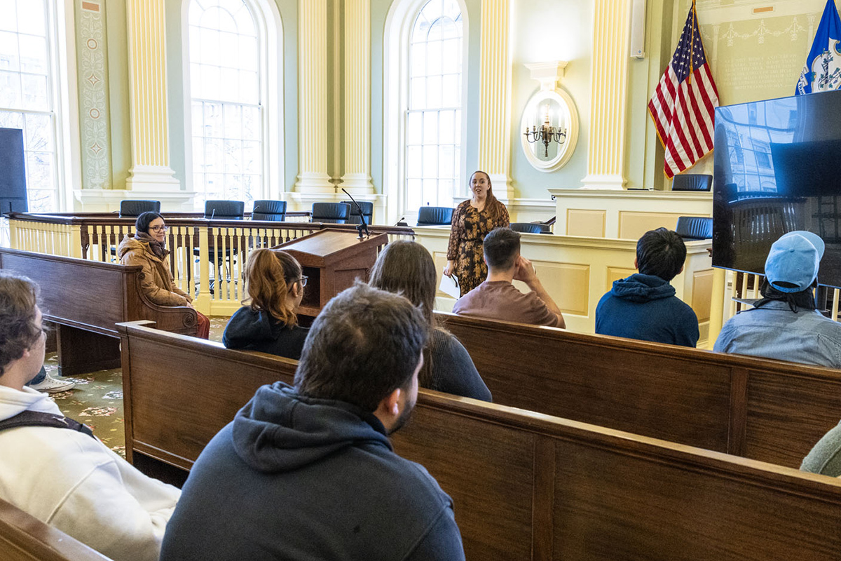 Students sit in pews at Waterbury City Hall.